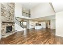 Spacious living room featuring a stone fireplace, hardwood floors, and an open floor plan at 6160 Hardwick Dr, Whitestown, IN 46075