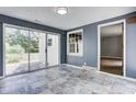 Bright sunroom features beautiful tile floors and a sliding glass door to the backyard at 6514 Jackson St, Indianapolis, IN 46241