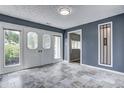 Spacious sunroom with decorative windows and tile flooring, perfect for relaxation at 6514 Jackson St, Indianapolis, IN 46241