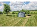 Backyard shed on a large lot with mature tree at 6702 W Willow Grove Dr, New Palestine, IN 46163