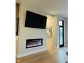 Living room with a sleek fireplace, TV, and modern design elements with natural lighting at 711 E 16Th St, Indianapolis, IN 46202