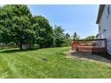 Expansive backyard featuring a large deck, mature trees, and a storage shed at 7168 Camwell Dr, Indianapolis, IN 46268