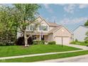 Inviting home with a manicured lawn, mature trees, and a welcoming front entrance at 7193 Wythe Dr, Noblesville, IN 46062