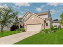 Attractive home features an attached two-car garage and a well-manicured lawn at 7193 Wythe Dr, Noblesville, IN 46062