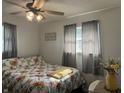 Bright bedroom features floral bedding, a ceiling fan, and plenty of natural light at 7346 E Buddy Ln, Camby, IN 46113