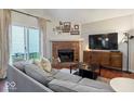 Comfortable living room with a brick fireplace, hardwood floors, and ample seating space at 7743 Waterwood Dr, Indianapolis, IN 46214