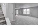 Bright living room with neutral paint, plush carpeting, and large windows providing ample natural light at 8030 Cork Bend Ln, Indianapolis, IN 46239