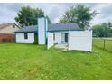 Spacious backyard featuring a white fence, well-maintained lawn and a patio area at 8318 Rob Ln, Indianapolis, IN 46237