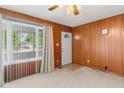Cozy living room with wood paneled walls, plush carpet, and ample natural light at 861 Westbrook Dr, Mooresville, IN 46158
