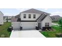 Charming two-story home featuring a three-car garage, well-manicured lawn, and stylish architectural details at 8690 Lester Pl, Pendleton, IN 46064