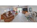 Comfortable living room with a ceiling fan and sliding doors to the outside patio at 8720 Yardley Ct # 207, Indianapolis, IN 46268