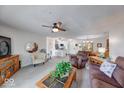 Open-concept living area with a ceiling fan, seamlessly connected to the kitchen and dining spaces at 8720 Yardley Ct # 207, Indianapolis, IN 46268