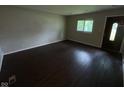 Bright living room features hardwood floors and large windows for natural light at 9045 Stardust Dr, Indianapolis, IN 46229