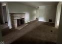 Cozy living room with a stone fireplace and views of the backyard at 9045 Stardust Dr, Indianapolis, IN 46229