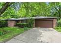 A single-story brick home with an attached garage and well-kept lawn at 9101 Ditch Rd, Indianapolis, IN 46260