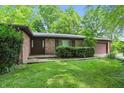 Attractive brick home with a well-manicured lawn and an attached garage at 9101 Ditch Rd, Indianapolis, IN 46260