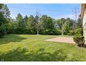 A spacious backyard with green grass and privacy from the surrounding woods at 9205 Selkirk Ct, Indianapolis, IN 46260
