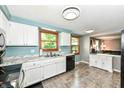 Spacious kitchen featuring white cabinets, ample counter space, and a double basin sink at 9402 Thornwood Dr, Indianapolis, IN 46250