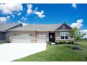 Beautiful single-story brick home with a spacious two-car garage and freshly sodded yard at 9671 Holborn Ave, McCordsville, IN 46055