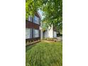 Inviting home exterior with blue shutters, brick accents and a well-manicured flower bed at 10042 Pine Grove Way, Indianapolis, IN 46234