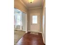 Inviting foyer with hardwood floors, a decorative rug and a view into the living room with neutral carpet at 1019 White Oak Dr, Plainfield, IN 46168