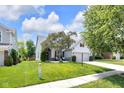 A well-maintained home featuring a green lawn and inviting curb appeal on a sunny day at 10215 Lauren Pass, Fishers, IN 46037