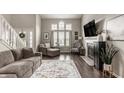 Inviting living room features hardwood floors, fireplace, lots of natural light, and a cozy seating area at 10380 Sand Creek Blvd, Fishers, IN 46037