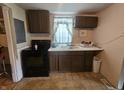 Traditional kitchen featuring dark wood cabinets and essential appliances at 1102 S Dequincy St, Indianapolis, IN 46203
