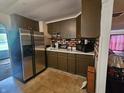 Kitchen with stainless steel refrigerator, ample counter space, and wooden cabinets at 1102 S Dequincy St, Indianapolis, IN 46203