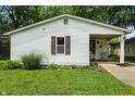 Inviting home featuring a well-maintained lawn and a cozy covered porch, perfect for relaxing outdoors at 1120 W 5Th St, Greenfield, IN 46140