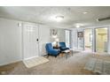 Cozy living room with plush carpeting, neutral walls, and comfortable seating, creating a relaxing space at 1120 W 5Th St, Greenfield, IN 46140