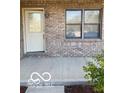 Close up of the front porch and entryway with a decorative front door and sidelight windows at 1128 Brookside Ct, Avon, IN 46123