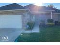 Charming single-story home with a brick facade, well-maintained lawn, and attached two-car garage at 1128 Brookside Ct, Avon, IN 46123