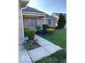 Well-manicured front yard with lush landscaping and a walkway leading to the entryway at 1128 Brookside Ct, Avon, IN 46123