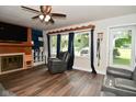 Cozy living room with hardwood floors, offering a fireplace and large windows for natural light at 11522 Newport Dr, Indianapolis, IN 46236