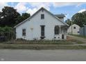 Charming two-story home featuring a classic design with a cozy front porch, ready for your personal touch at 121 School St, Greenfield, IN 46140