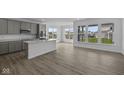 Open-concept kitchen and living area with large windows, modern finishes, and hardwood floors, creating a bright atmosphere at 12490 Morning Ridge Way, Noblesville, IN 46060
