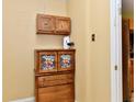 Close up on wall decor, including cabinets, a paper towel dispenser, and strawberry decor at 1252 Jasmine Dr, Greenfield, IN 46140
