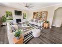 Bright, staged living room featuring a fireplace, hardwood floors, and modern decor at 1359 Shadow Ridge Rd, Indianapolis, IN 46280