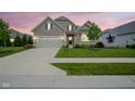 This home features a manicured lawn and inviting walkway leading to the front door at 16209 Natures Way, Westfield, IN 46074