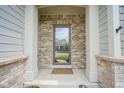 Inviting front entryway with brick columns and a welcoming 'Welcome' mat at 16209 Natures Way, Westfield, IN 46074