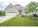 Charming home features a manicured lawn, two-car garage, and beautiful landscaping at 16209 Natures Way, Westfield, IN 46074