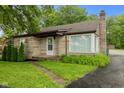 Charming stone-clad home with well-manicured lawn and a classic chimney at 1631 S Post Rd, Indianapolis, IN 46239