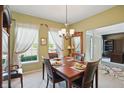 Charming dining room featuring a wooden table set for four, with lots of natural light at 18112 Kinder Oak Dr, Noblesville, IN 46062