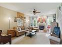 Spacious living room with a cozy fireplace, plush seating, and an abundance of natural light at 18112 Kinder Oak Dr, Noblesville, IN 46062