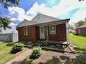 Beautiful brick home featuring a covered porch and landscaped front yard at 1908 S Biltmore Ave, Muncie, IN 47302