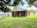 Inviting brick home with a green lawn and a charming pathway to the front door at 1908 S Biltmore Ave, Muncie, IN 47302