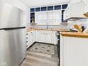 Bright kitchen with stainless steel appliances, white cabinets, and wood countertops at 1910 W 10Th St, Anderson, IN 46016