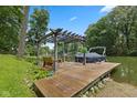 Private boat dock with pergola cover offering stunning views of the calm lake waters at 1927 E Derby Ct, Martinsville, IN 46151