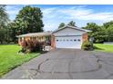 Beautiful brick home featuring an attached garage, a covered front porch and a well-kept lawn at 2608 E 500 N, Whiteland, IN 46184